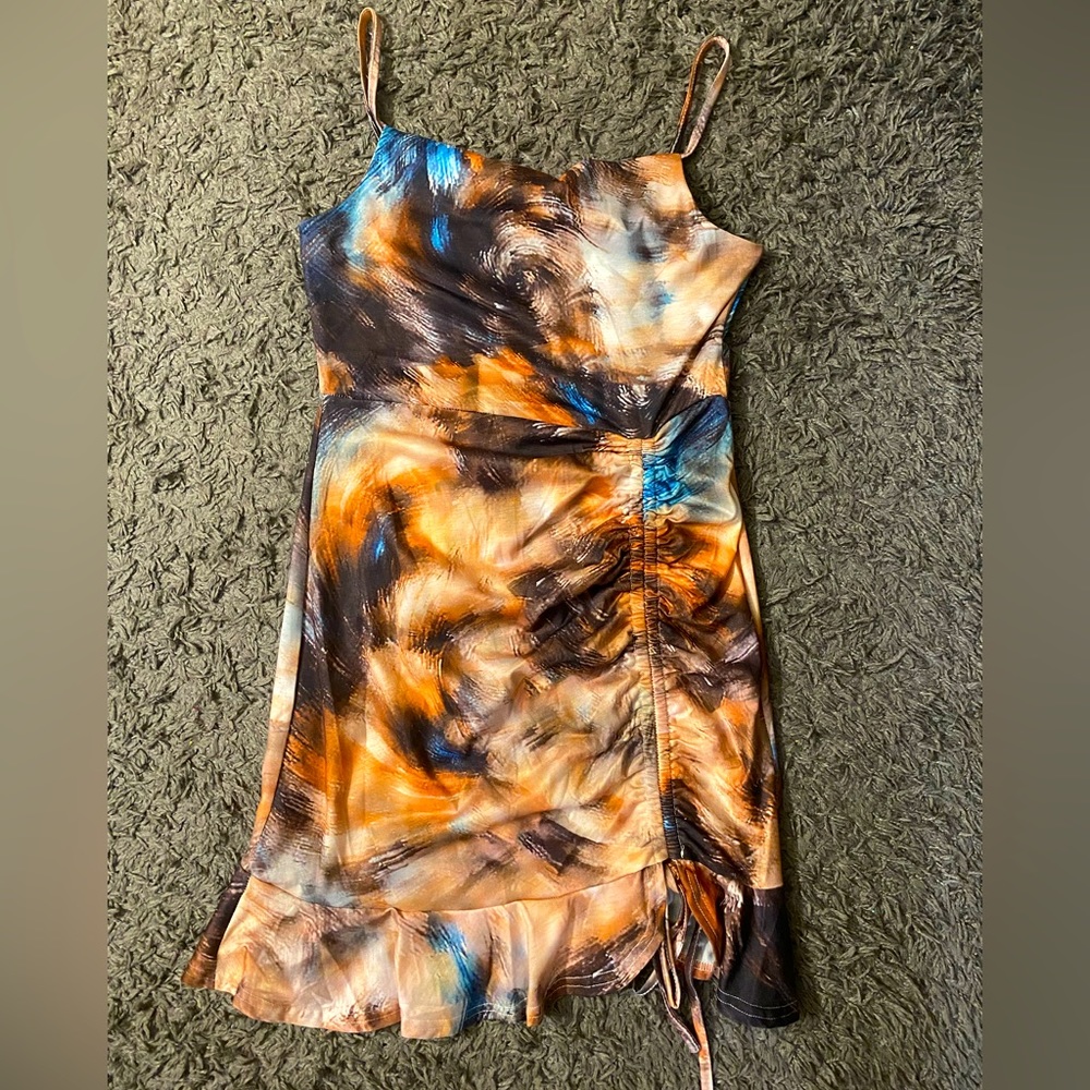 Mini brown dress with a lot of details. The dress compliments the females body.